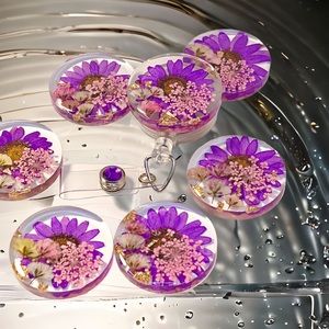 Badge reel with purple daisy, pink Queen Anne's, and baby's breath.